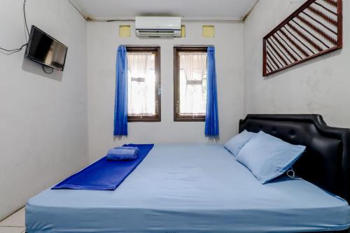 Homestay Damandiri Prambanan Syariah tesisinde bir odada yatak veya yataklar