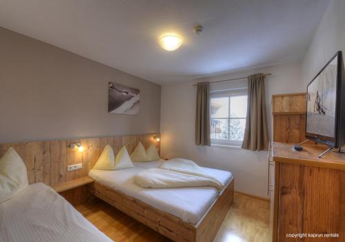 Voodi või voodid majutusasutuse Ski & Golf Apartments by Kaprun Rentals toas