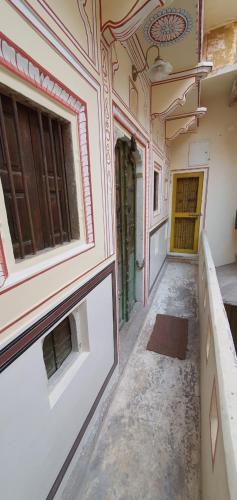 an empty hallway in an old building with a door at Jaipur Haveli in Jaipur