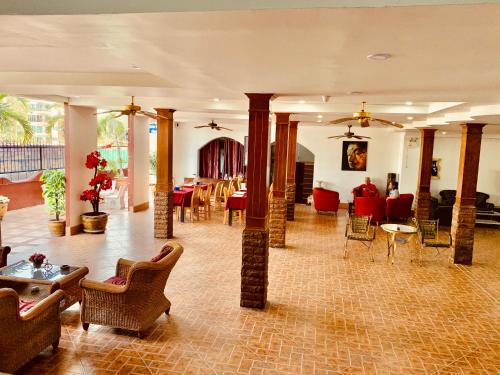a lobby with chairs and tables in a building at Sun & Beach in Pattaya South