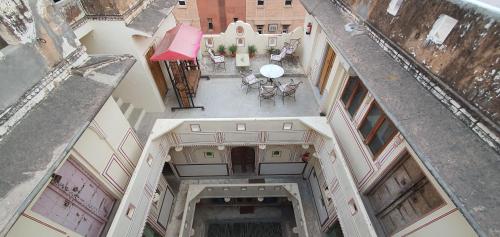 an overhead view of a building with a table and chairs at Jaipur Haveli in Jaipur