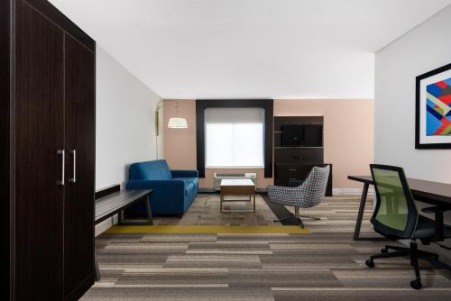 a living room with a blue couch and chairs at Holiday Inn Express Hillsville by IHG in Hillsville
