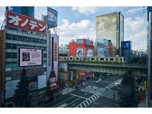 a city with a train crossing a street with buildings at NOHGA HOTEL AKIHABARA TOKYO in Tokyo