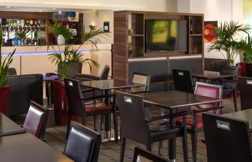 a dining room filled with tables and chairs at Holiday Inn Express London - Dartford, an IHG Hotel in Dartford