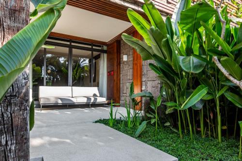 a patio with a couch and some plants at The Bale Villas牛眠埔里 in Puli