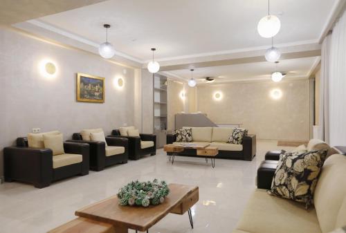 a large living room with couches and a table at Sunset Terrace Mestia in Mestia