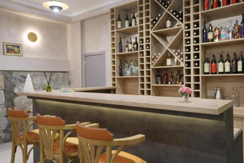 a bar with chairs and bottles of wine at Sunset Terrace Mestia in Mestia