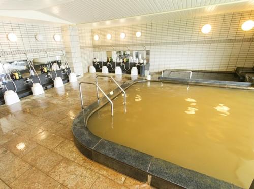 a large pool of water in a large room at The Gran Resort Arima in Kobe