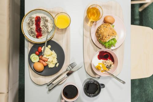 two pictures of plates of food on a table at GreenStar Hotel Vaasa in Vaasa