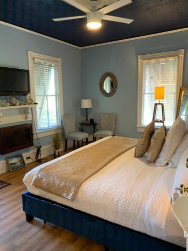a bedroom with a large bed and a tv at Peace & Plenty Inn Bed and Breakfast Downtown St Augustine-Adults Only in Saint Augustine