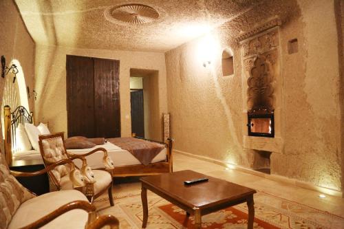 a hotel room with a bed and a living room at Roma Cave Suite in Goreme