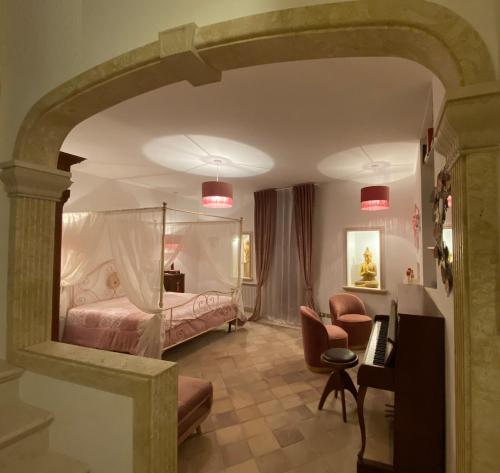 a bedroom with a bed and a table and chairs at DON GIL CHIC in Polignano a Mare