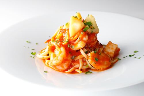 a plate of pasta on a white plate at Hotel New Otani Tokyo The Main in Tokyo