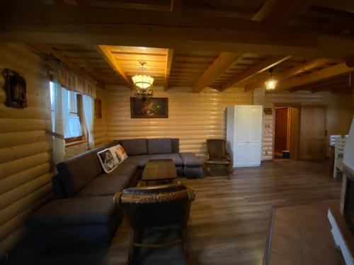 a living room with a couch and a table at Chatka Katka in Liptovský Mikuláš