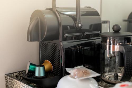 a counter with a coffee maker and a coffee pot at Beach Villa Wilderness in Wilderness
