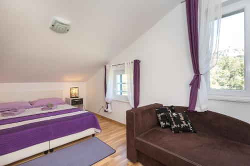 a bedroom with a bed and a couch at Relax 3 in Baška