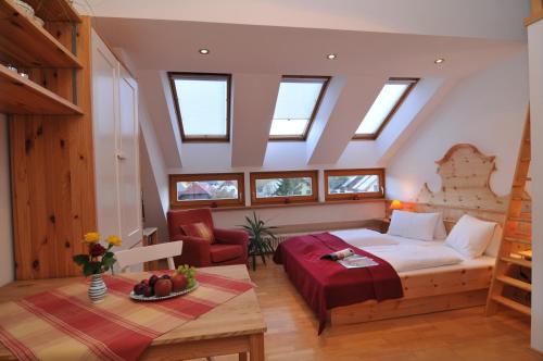 a attic bedroom with a bed and a table at Haus Schitter in Mauterndorf