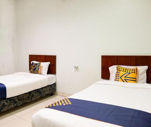Cama ou camas em um quarto em SPOT ON 2182 Al-ghani 2 Syariah