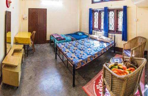 a room with two beds and a table and chairs at Blissful Eyrie in Guwahati