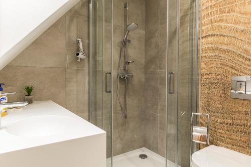 a bathroom with a shower with a glass door at Royal Hill Residence in Zakopane