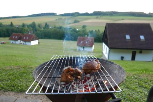 a person is cooking food on a grill at Green Valley Park in Stárkov