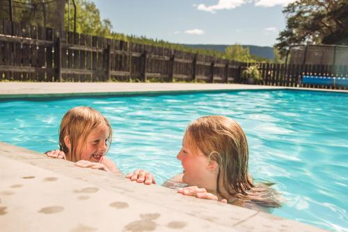 two young girls swimming in a swimming pool at Toftemo Turiststasjon in Dovre