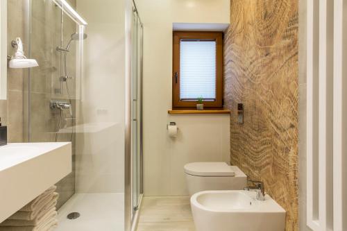 a bathroom with a toilet and a sink and a shower at Royal Hill Residence in Zakopane