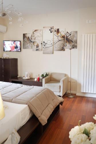 a bedroom with a bed and a couch and a chair at Pompeii Ruins De Charme B&B in Pompei