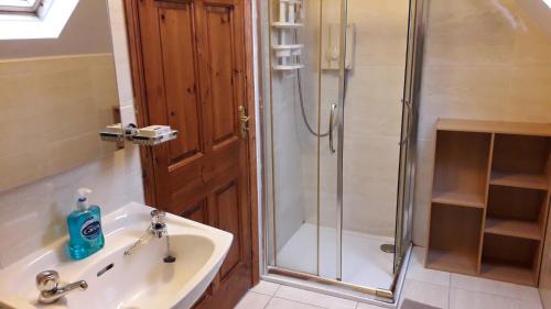 a bathroom with a shower, sink, and toilet at Easdale B&B in Ballyduff