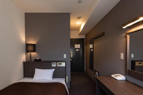 Cama ou camas em um quarto em Hotel Etwas Tenjin