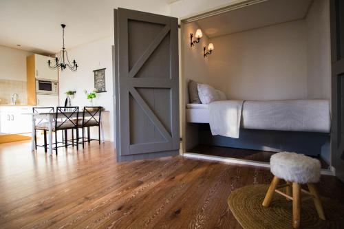 a bedroom with a bed and a sliding barn door at T'hûs bed & breakfast in Katlijk
