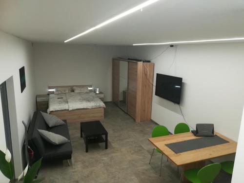 um quarto com uma cama, uma mesa e um sofá em Place near Casino Mond - Apartma Urška em Sentilj