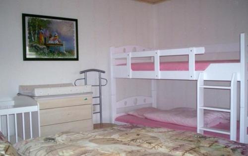 a bedroom with two bunk beds and a desk at Ferienhaus-Bender-Rügen in Maltzien