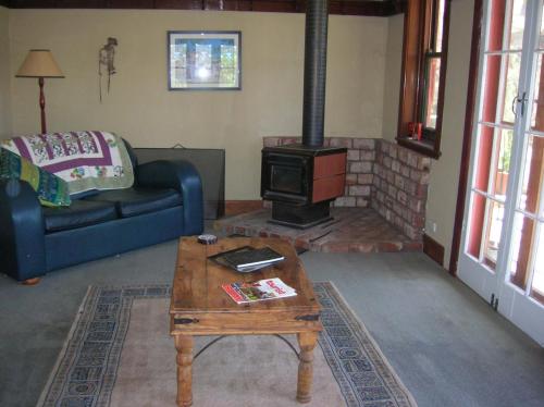 a living room with a couch and a wood stove at Kinross Metcalfe Farm in Metcalfe
