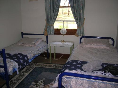 a bedroom with two beds and a window at Kinross Metcalfe Farm in Metcalfe