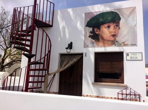 a building with a painting of a woman with a green hat at ZARATUSTRA. Rodalquilar CENTRO. GRAN terra. WIFI in Rodalquilar