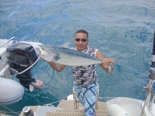 a man holding a fish on a boat at Bel Air Hotel in Victoria