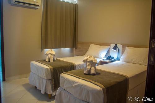 Ένα ή περισσότερα κρεβάτια σε δωμάτιο στο Hotel Enseada Aeroporto