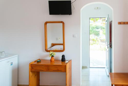 a room with a wooden table and a mirror at Themonia in Apollonia