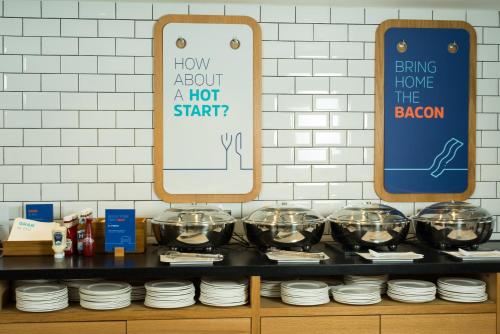 a display of bowls and plates on a shelf at Holiday Inn Express Birmingham Airport NEC by IHG in Bickenhill