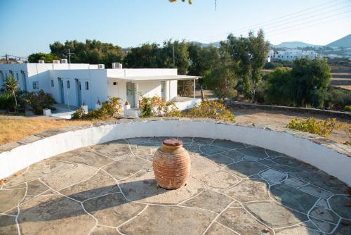 a vase sitting on a stone patio in front of a house at Themonia in Apollonia