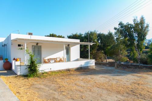 a small white house on the side of a field at Themonia in Apollonia