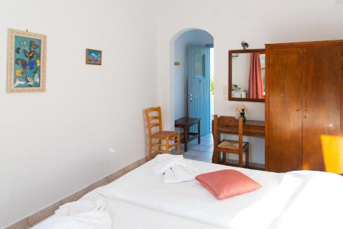 a bedroom with a bed and a desk and a mirror at Themonia in Apollonia