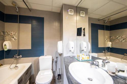 a bathroom with a toilet and a sink at Spa Hotel Ezeretz Blagoevgrad in Blagoevgrad