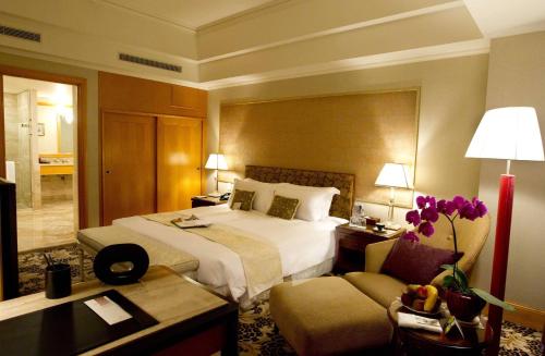 a hotel room with a bed and a couch at THE LEES Hotel in Kaohsiung