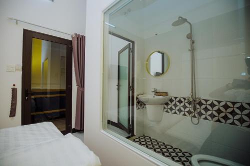 a bathroom with a shower and a sink at Rome Hostel in Tuy Hoa
