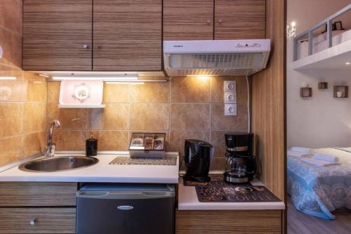 a small kitchen with a sink and a stove at Rodia in Volos