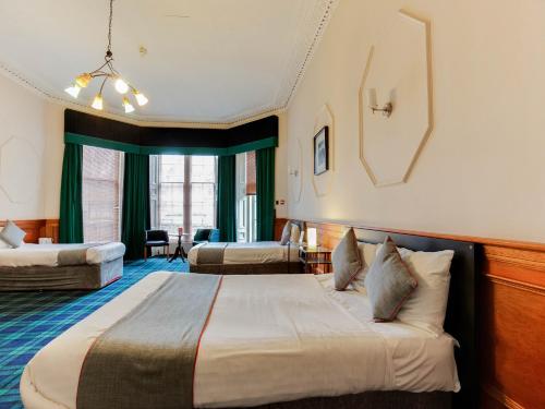 Säng eller sängar i ett rum på Lost Guest House Stirling