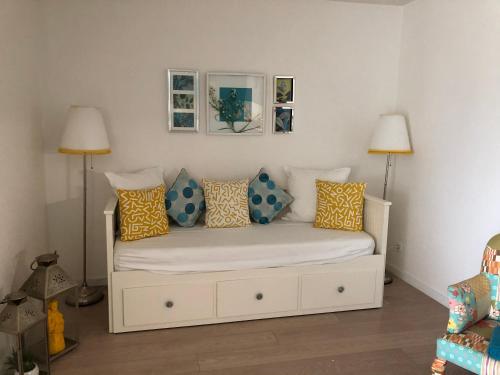 a bedroom with a bed with pillows on it at Amazing Beach & Pool Apartment with Garden in Sesimbra