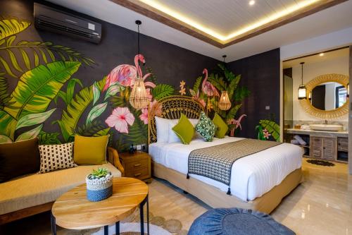 a bedroom with a king sized bed and a couch at The Akasha Boutique Hotel in Seminyak